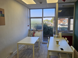 Inside a retail unit. Tables and chairs can be seen